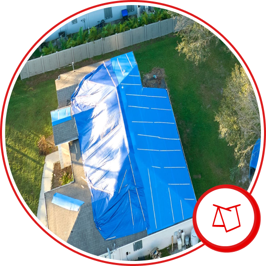 Aerial view of blue tarp covering damaged roof on residential home after storm