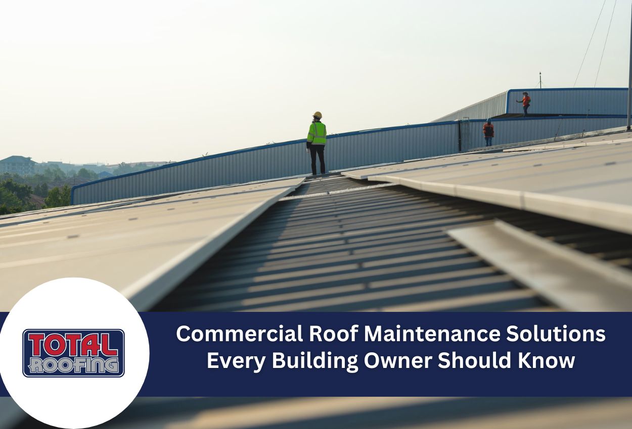 Construction workers on commercial building roof performing maintenance and repairs